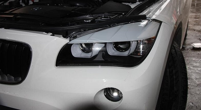 BMW X1 E84 FARI ANTERIORI NERI ANGEL EYES 3D LENTICOLARI H7 / H7 AUTOELEGANCERICAMBI