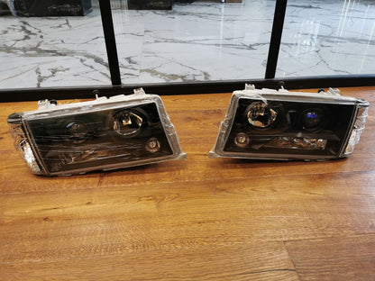 FARI ANTERIORI ADATTI PER MERCEDES 190 W201 1982-1993 LOOK NERI DESIGN SPORTIVI