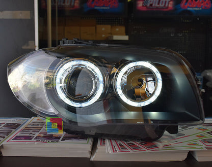 FARI NERI CON ANELLI ANGEL EYES BMW SERIE 1 E81 E82 E87 E88 04-11 LED BIANCHI -.