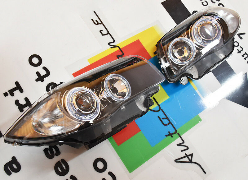 FARI NERI CON ANELLI ANGEL EYES BMW SERIE 1 E81 E82 E87 E88 04-11 LED BIANCHI -.