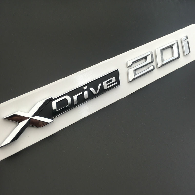 BMW X3 X4 X5 X6 1x LOGO X DRIVE 2.0 DECORATIVO CROMATO E NERO ADESIVO AUTOELEGANCERICAMBI