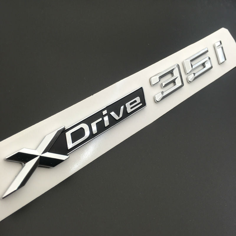 BMW X3 X4 X5 X6 1x LOGO X DRIVE 4.8 DECORATIVO CROMATO E NERO ADESIVO AUTOELEGANCERICAMBI