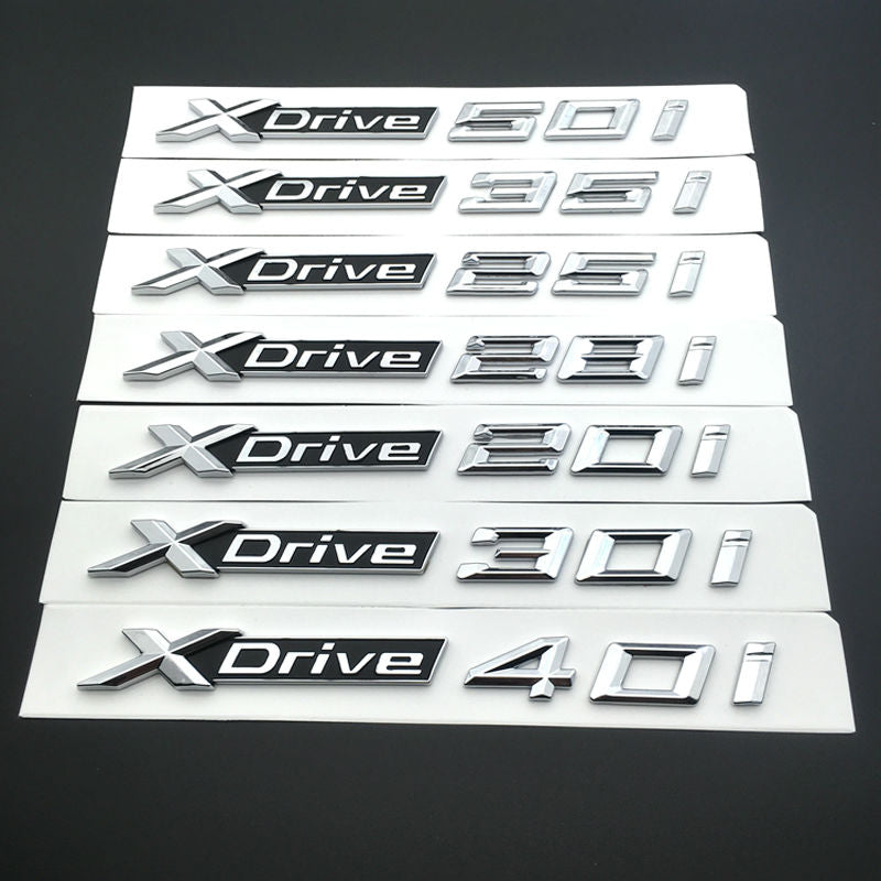 BMW X3 X4 X5 X6 1x LOGO X DRIVE 3.0 DECORATIVO CROMATO E NERO ADESIVO AUTOELEGANCERICAMBI