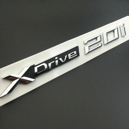 BMW X3 X4 X5 X6 1x LOGO X DRIVE 2.0 DECORATIVO CROMATO E NERO ADESIVO AUTOELEGANCERICAMBI